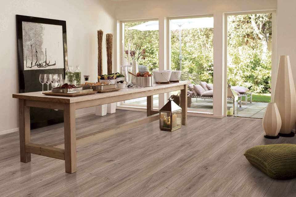 medium toned luxury vinyl plank in dining area with sliding pocket doors to outdoor patio